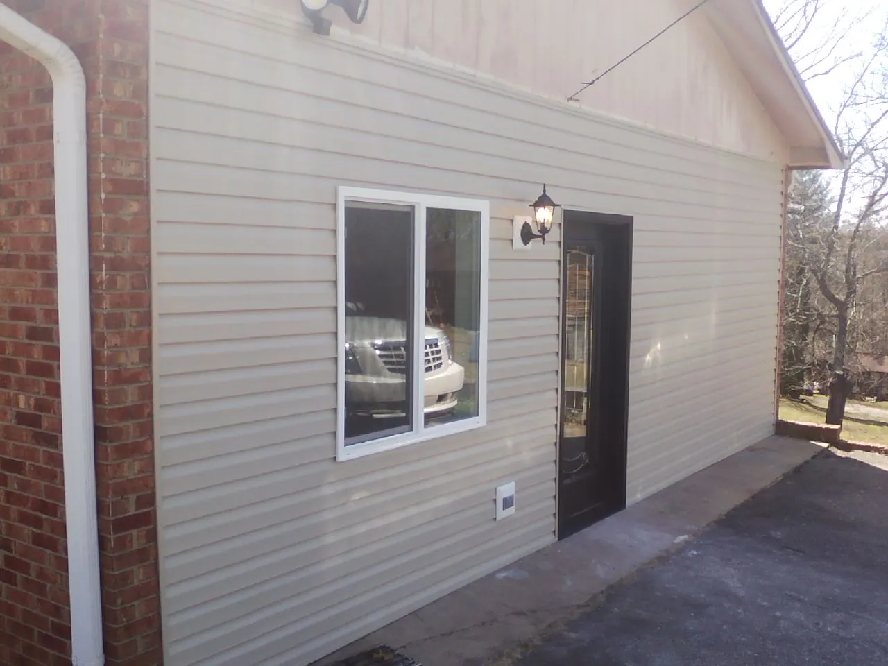 New vinyl siding and entry door on a room addition in Orchard