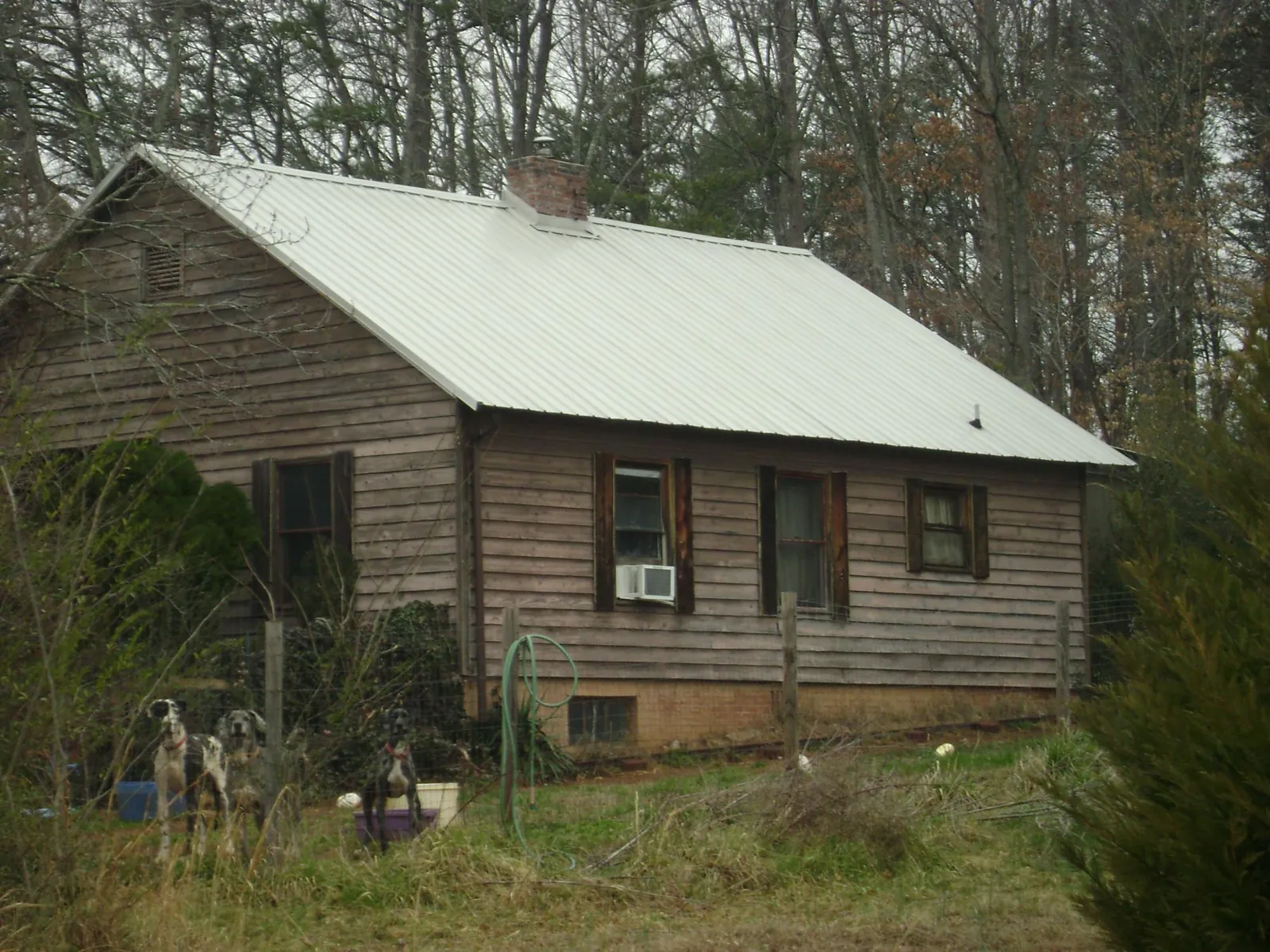White metal roof on an old wood sided farmhouse, from a Metal Roof Installation job in Orchard